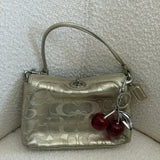 Gold Legacy Turnlock Coach Signature Mini Bag
